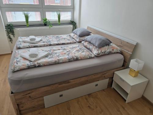 a bedroom with a bed with a wooden headboard at Spirit apartments Brno, with parking in Brno