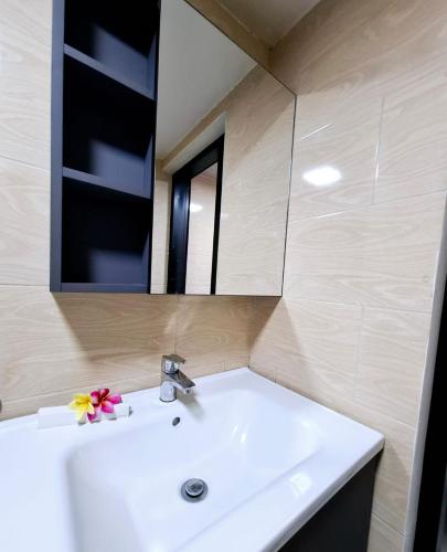 a bathroom with a white sink and a mirror at Pondok Denly by Pigeon in Nusa Dua