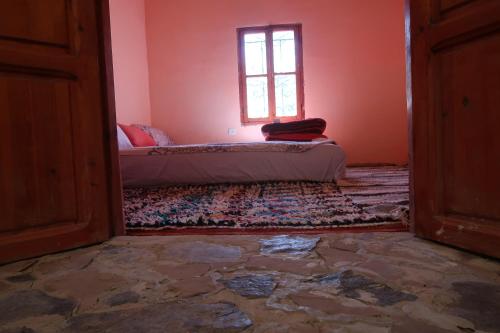 an empty room with a bed and a window at Gite Megdaz in Megdaz