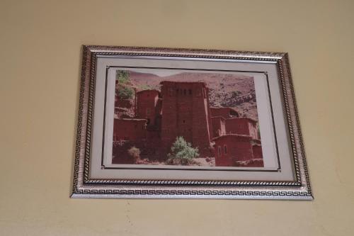 a framed picture of a building on a wall at Gite Megdaz in Megdaz