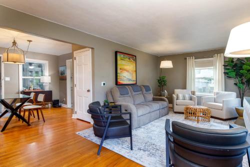a living room with a couch and chairs and a table at Crane Haven - Walk to CyRide Games & Grill in Ames