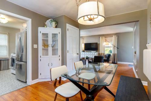 a dining room and living room with a glass table and chairs at Crane Haven - Walk to CyRide Games & Grill in Ames