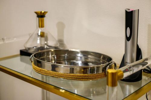 a metal bowl on top of a counter with a knife at Crane Haven - Walk to CyRide Games & Grill in Ames