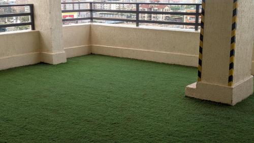 an empty room with green flooring in a building at Krystal suites in Juja