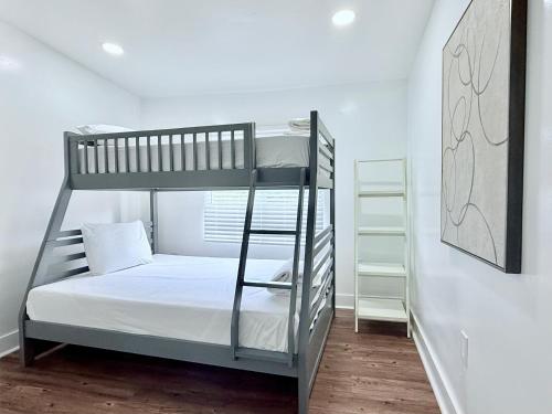 a bedroom with two bunk beds and a ladder at Renzzi Villas in Miami