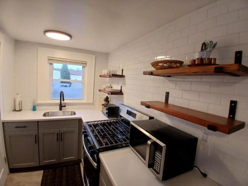 a kitchen with a stove top oven next to a sink at A Quiet Spot in Bloomfield, NJ in Bloomfield