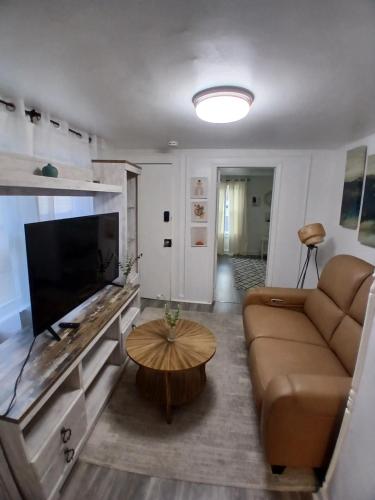 a living room with a couch and a table at A Quiet Spot in Bloomfield, NJ in Bloomfield