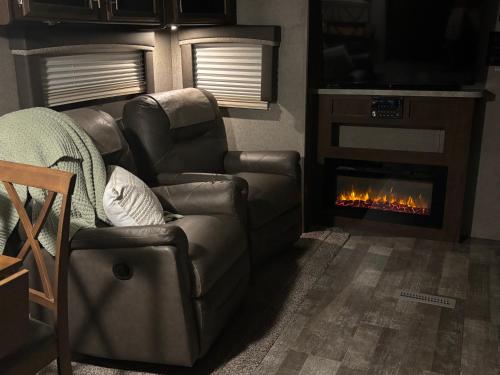 a living room with a couch and a fireplace at Skull Creek custom 2 in Round Top