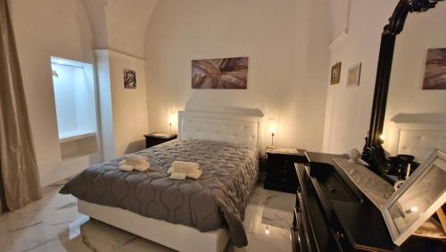 a bedroom with a bed with two towels on it at La Corte dei Sarti in Copertino