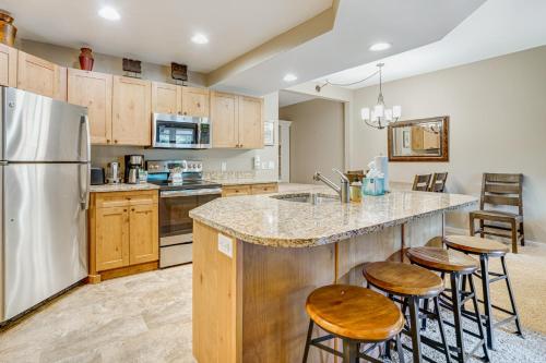 a kitchen with a large island with bar stools at Walk to Lifts Copper Mtn Condo in Center Village! in Frisco