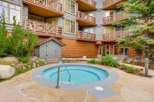 a building with a swimming pool in front of a building at Walk to Lifts Copper Mtn Condo in Center Village! in Frisco