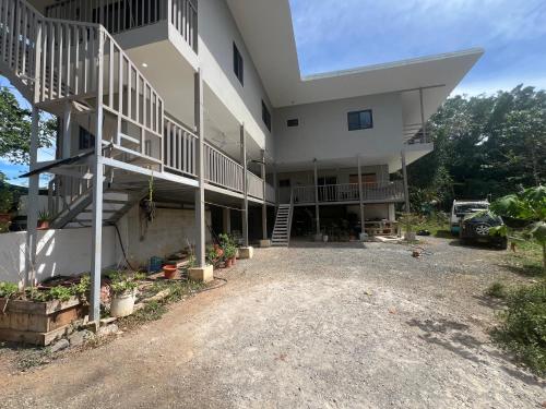 a large white building with stairs and a parking lot at Pura Vida 2 Bed 2 Bath Montezuma in Montezuma