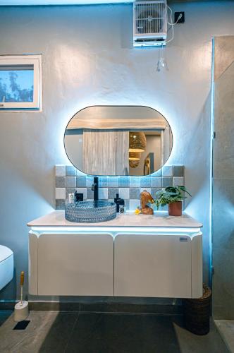 a bathroom with a white sink and a mirror at Amshiga 1 in Jimbaran