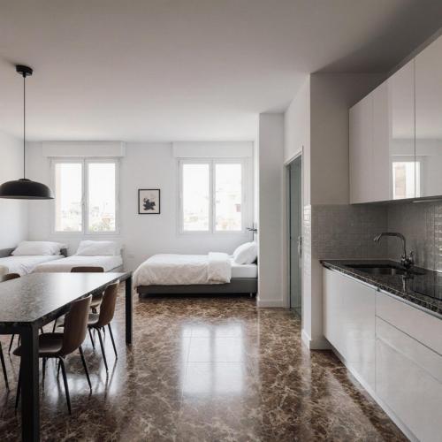 a kitchen and living room with a bed and a table at House close to airport in El Prat de Llobregat
