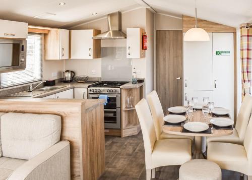 a kitchen and dining room with a table and chairs at Hanworth Country Park in Potter Hanworth