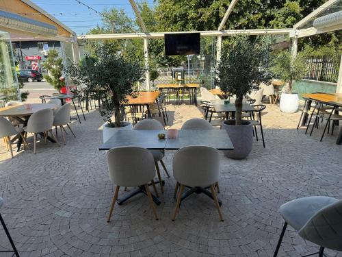 a group of tables and chairs in a patio at Boutique Hotel Balș in Balş
