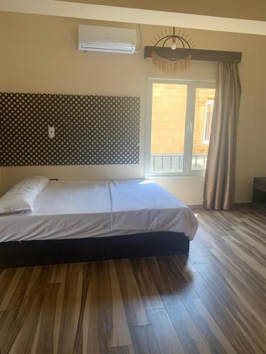 a bedroom with a bed and a large window at Ghazala Bay Hotel in Dahab