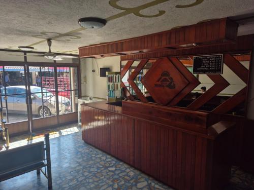 a restaurant with a counter and a bench in a room at Hotel Moncho in Balancán de Domínguez