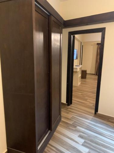 a room with a door and a hallway with wood floors at Ghazala Bay Hotel in Dahab