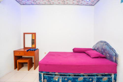 Ένα ή περισσότερα κρεβάτια σε δωμάτιο στο Guest House Mantingan