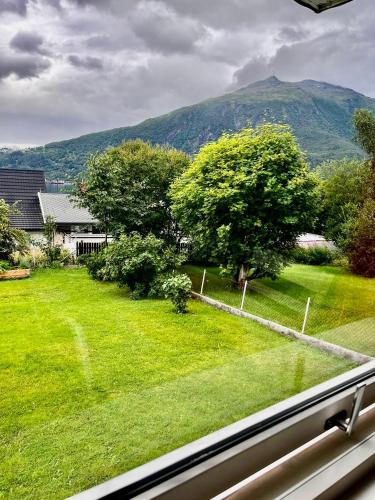 a view from a window of a yard with a mountain at Apartment in Narvik