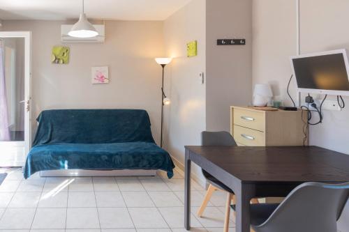 a living room with a couch and a table at Gîte Chêne ou Murier in Les Vans
