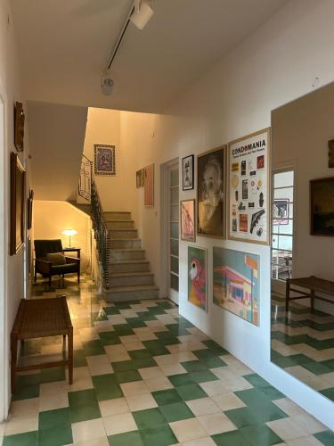 a living room with a checkered floor and stairs at Harbour of Colours in Pieta