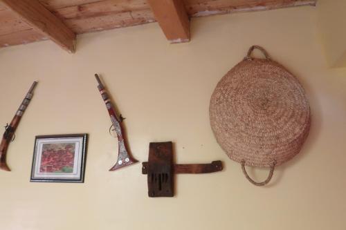 a wall with several different kinds of weapons on it at Gite Megdaz in Megdaz