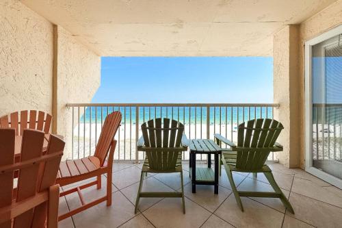 a table and chairs on a balcony with the ocean at Driftwood Towers 5F in Gulf Shores