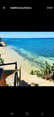 a television screen showing a beach with the ocean at Beach house near ochi Rios and Ian Fleming airport in Salt Gut Pen