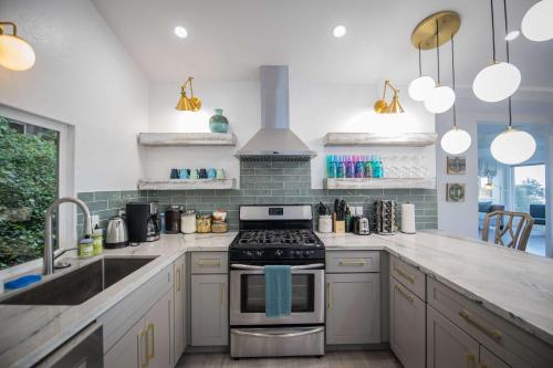 a kitchen with a stove and a sink at Coastal Charm - Oceanview Stay in Pacifica Near SF in Pacifica