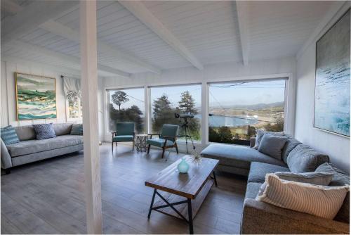 a living room with couches and a table at Coastal Charm - Oceanview Stay in Pacifica Near SF in Pacifica