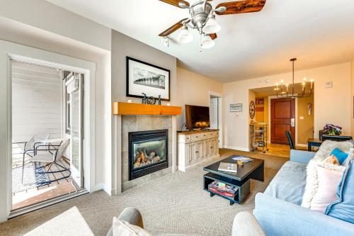 a living room with a blue couch and a fireplace at Ski-InandSki-Out Winter Park Condo with Balcony in Winter Park