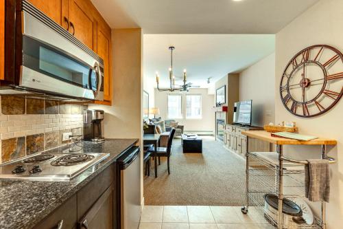 a kitchen and living room with a counter top at Ski-InandSki-Out Winter Park Condo with Balcony in Winter Park