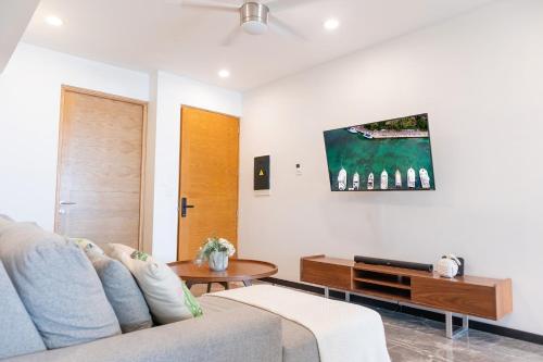 a living room with a couch and a table at It Beach Condo in Playa del Carmen