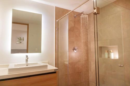 a bathroom with a sink and a shower at It Beach Condo in Playa del Carmen