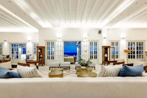 a living room with a large white couch at San Marco Hotel and Villas in Houlakia