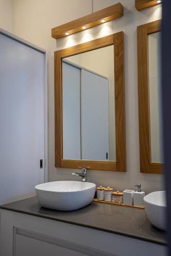 a bathroom with a sink and a mirror at Villa Pwani in Baie du Tombeau