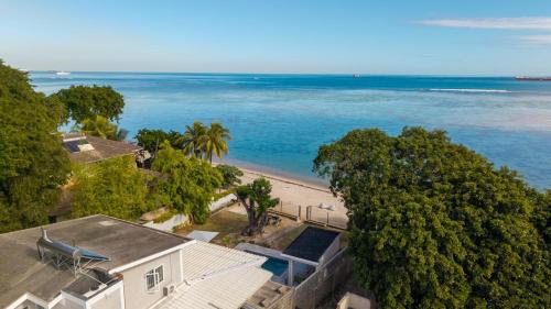 an aerial view of a house and the beach at Villa Pwani in Baie du Tombeau