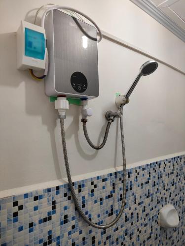 a shower in a bathroom with a shower at Bogah Lodge in Banaue