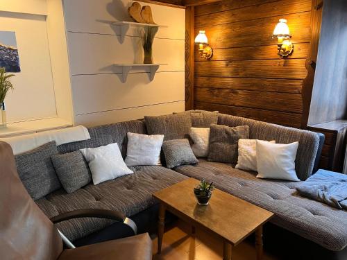 a living room with a couch and a table at Fewo Edelweiss in Nesselwängle
