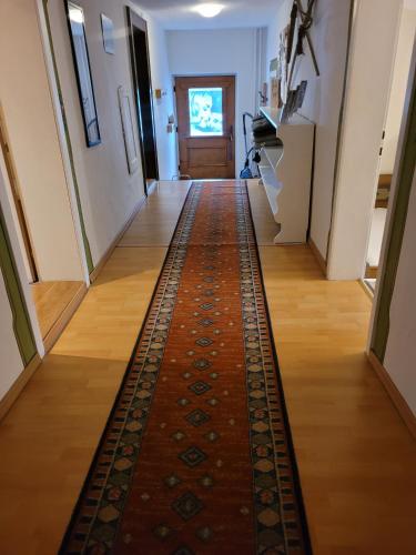 a hallway with a rug on the floor at Fewo Edelweiss in Nesselwängle