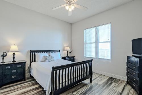 a bedroom with a bed and a tv and a window at The Wharf 912 in Orange Beach