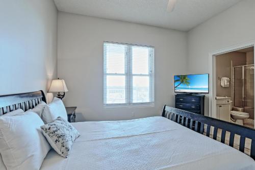 a bedroom with a large bed and a television at The Wharf 912 in Orange Beach