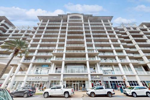 a large building with cars parked in front of it at The Wharf 912 in Orange Beach