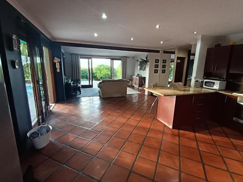 a kitchen and living room with a tile floor at Happy Homes - Imhoffs Gift in Imhoffʼs Gift