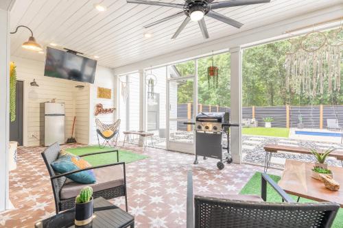 a screened in porch with chairs and a grill at The Southern Oasis in Pleasant View