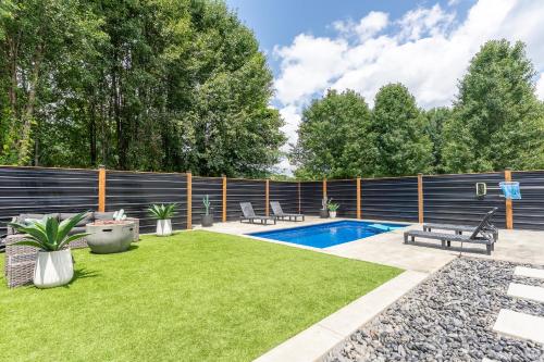 a backyard with a swimming pool and a fence at The Southern Oasis in Pleasant View