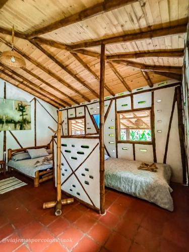 a bedroom in a house with two beds at Hotel La Casa de Francois in San Agustín
