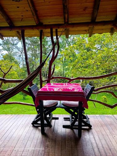 a table and chairs sitting on a porch at Hotel La Casa de Francois in San Agustín